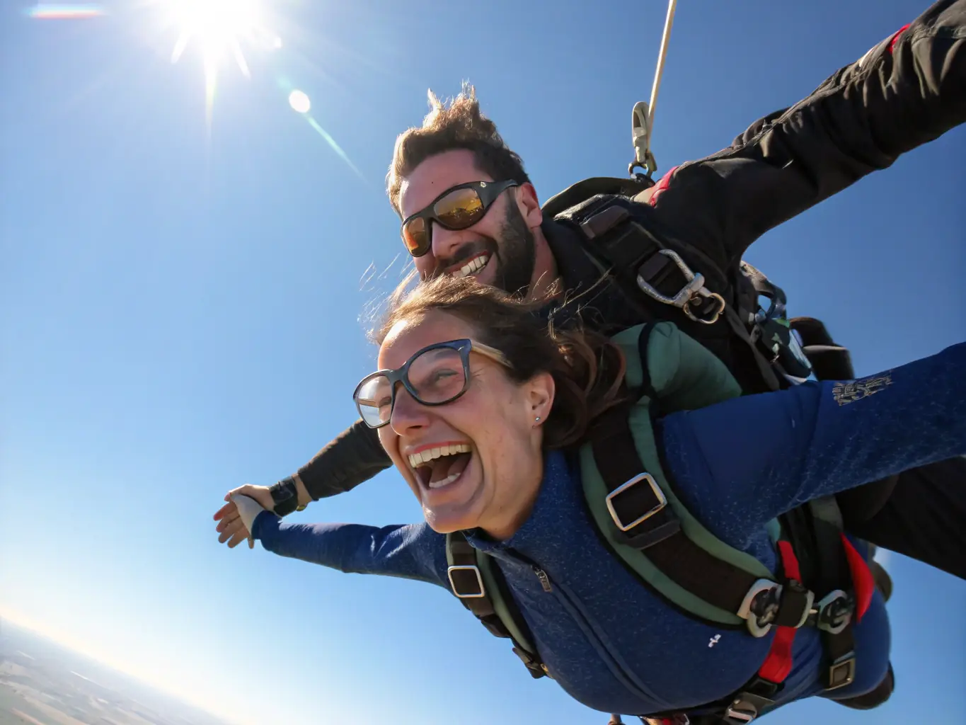 A scenic photograph of a tandem paragliding flight over the Bourgogne countryside, with a smiling instructor and participant enjoying panoramic views of vineyards and forests.
